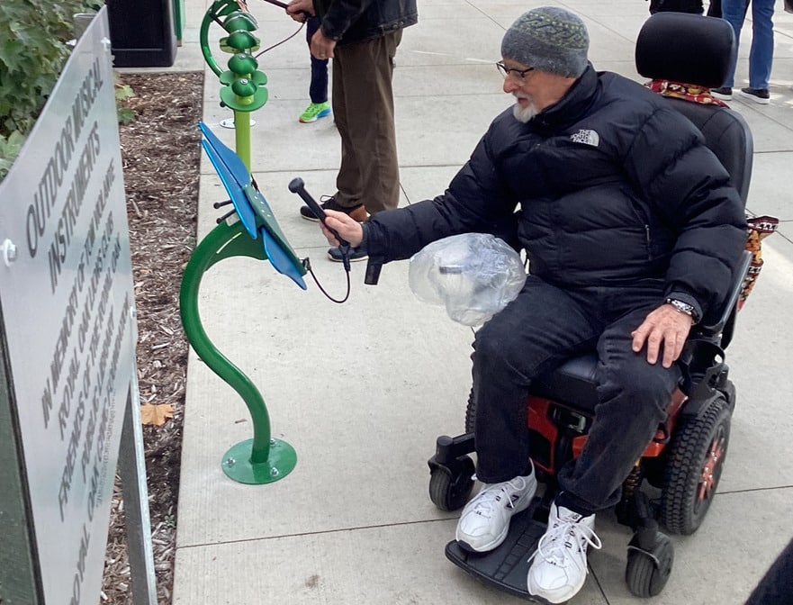 A users tries the accessible musical instruments at the Royal Oak library.
