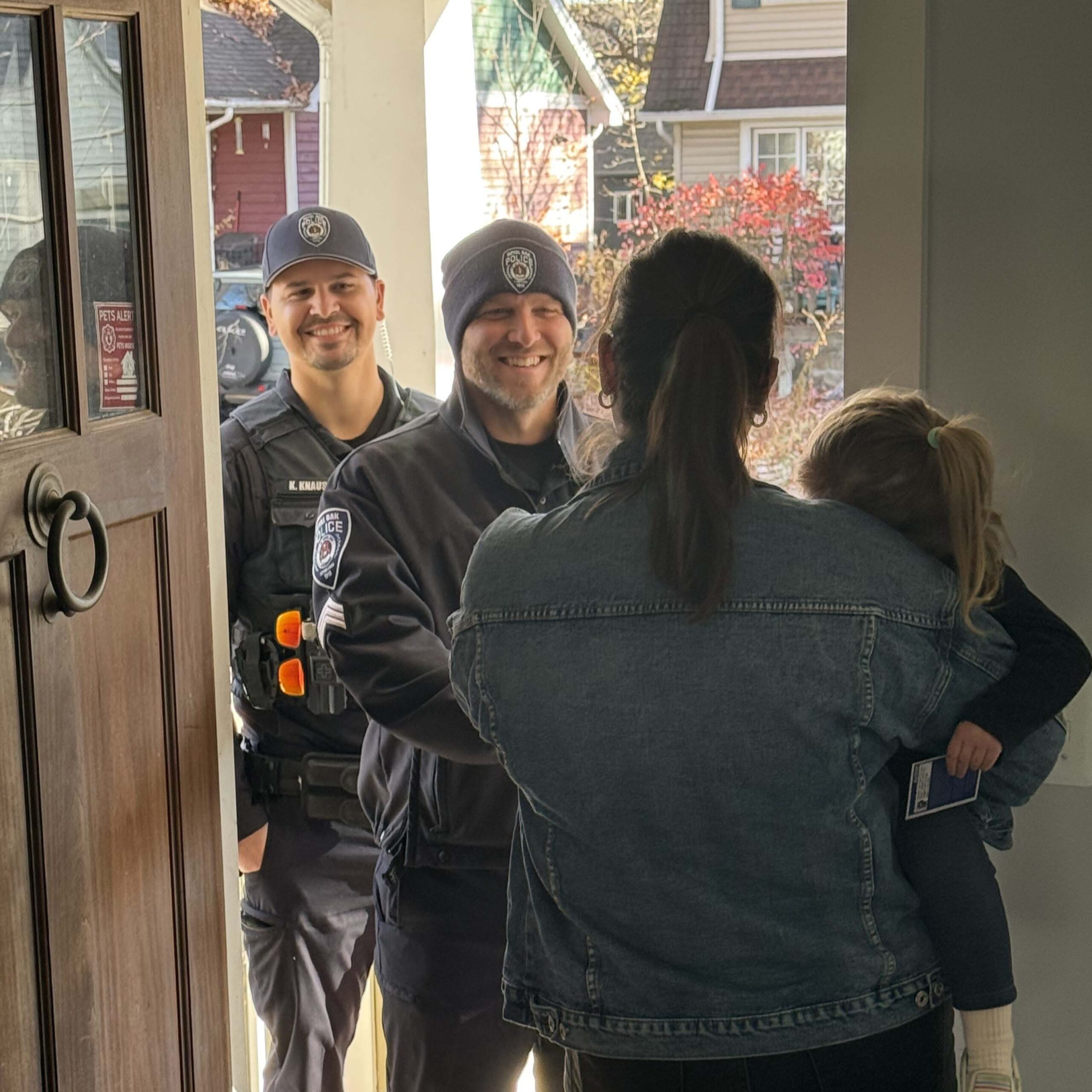Police officers with woman and child