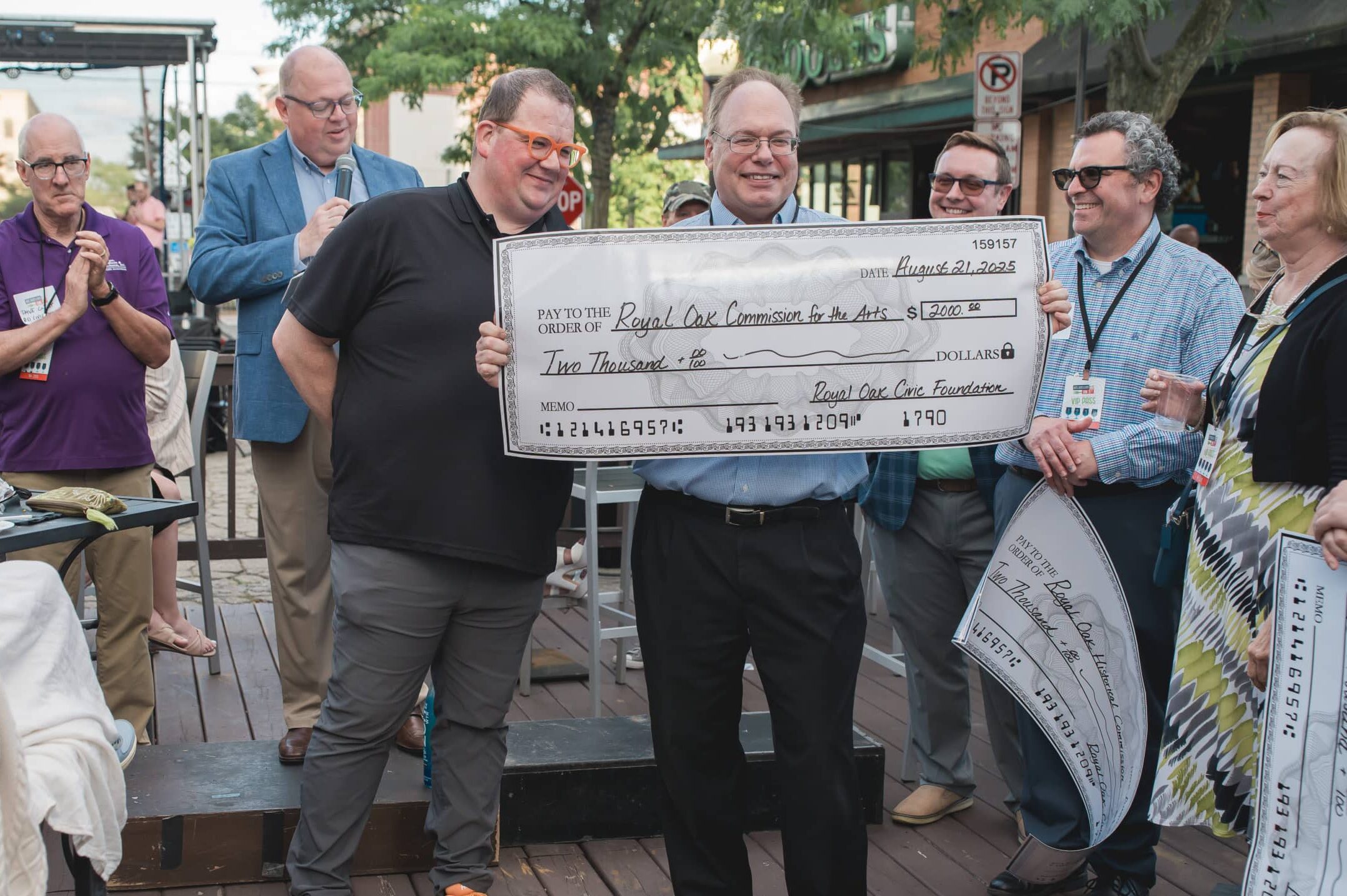 Board member hands check to beneficiary organization